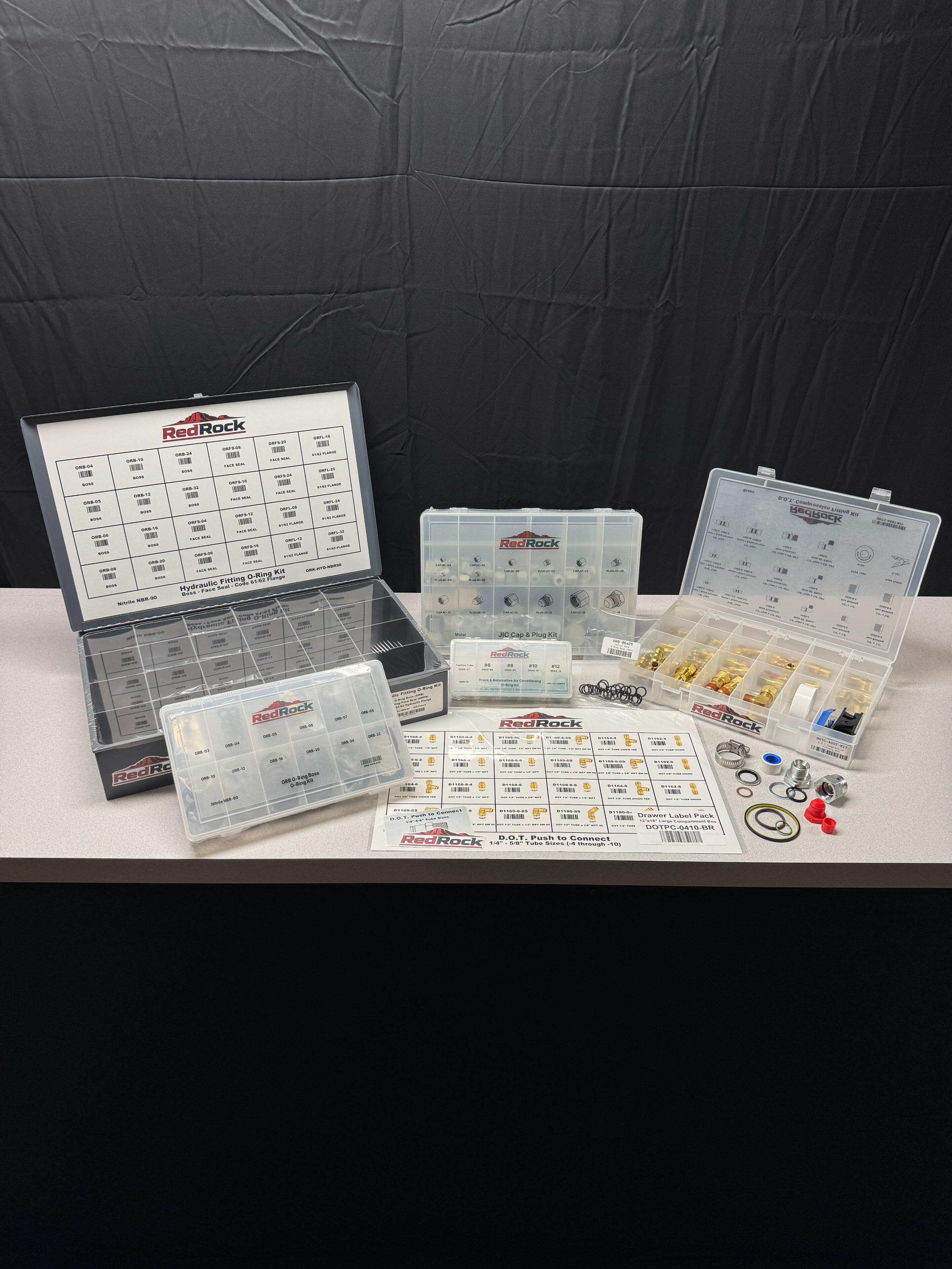 Distributor private-label assortment kits with lid charts, refill packs, drawer label packs, and components.